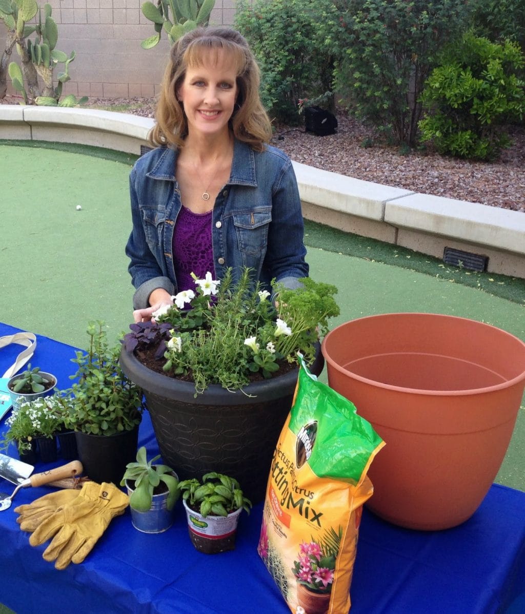 Posing next to my newly-planted container filled with purple basil, thyme, rosemary and parsley.  White petunias add beauty to the pot.