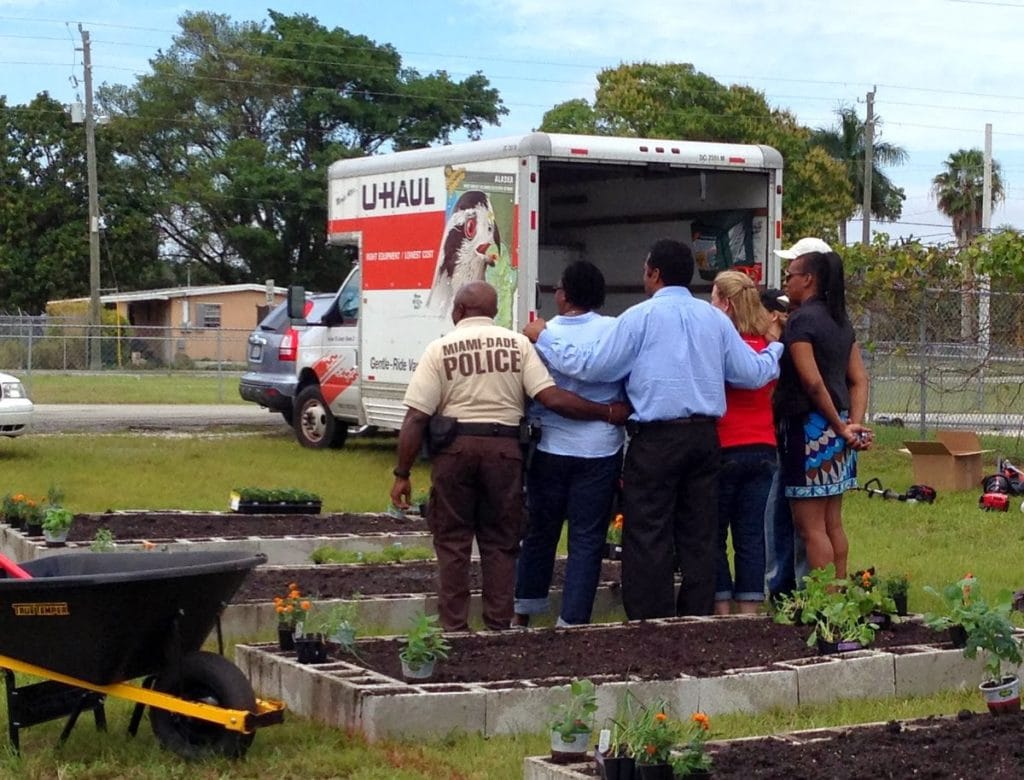 Community members posing for a picture with a Troybilt representative