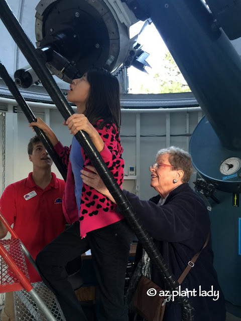  My mother, helping my daughter as she looks at Saturn. 