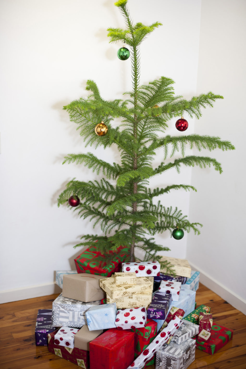 Christmas tree with disco ball ornaments and packages of garden gifts