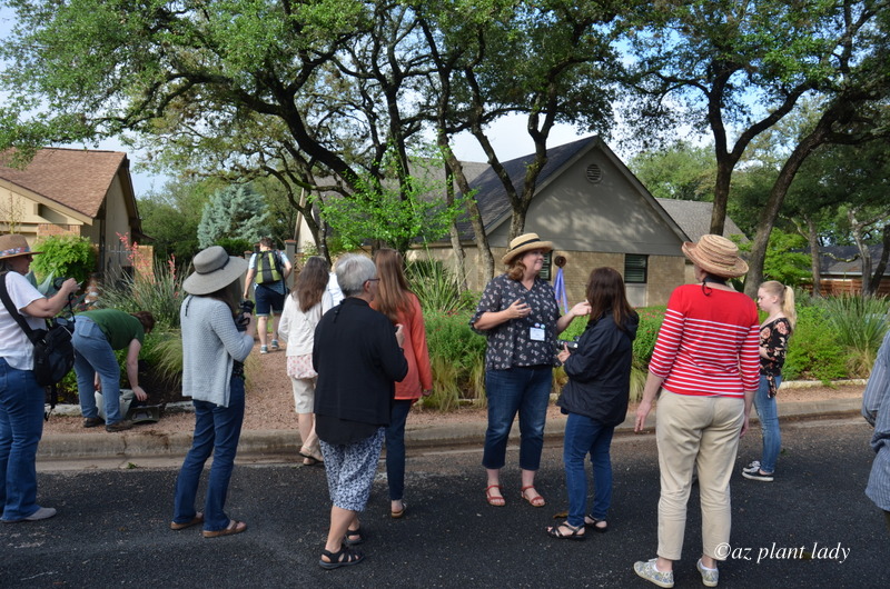 Pam Penick (facing front wearing a hat) greeting garden visitors in her shady colorful garden 