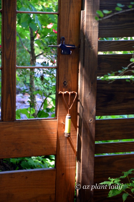 A unique handle for a door - a hand cultivator welded to the garden gate. Southwest garden style