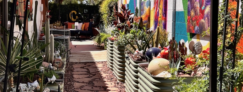 side garden with art on walls and raised beds